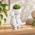 Dino Drift dinosaur rider planter in a warm styled shelf setting