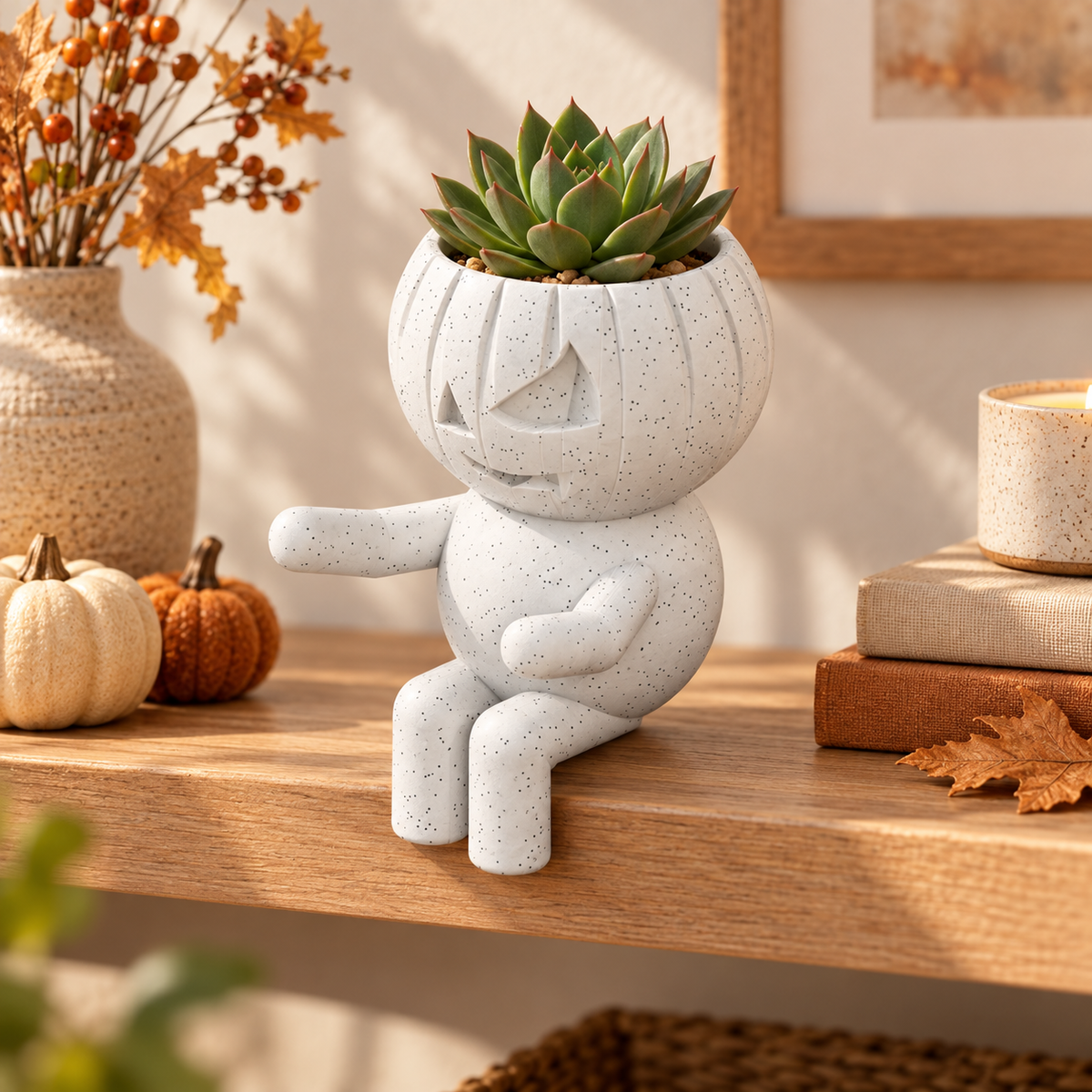 Pumpkin Pippin jack-o-lantern planter in a warm styled shelf setting